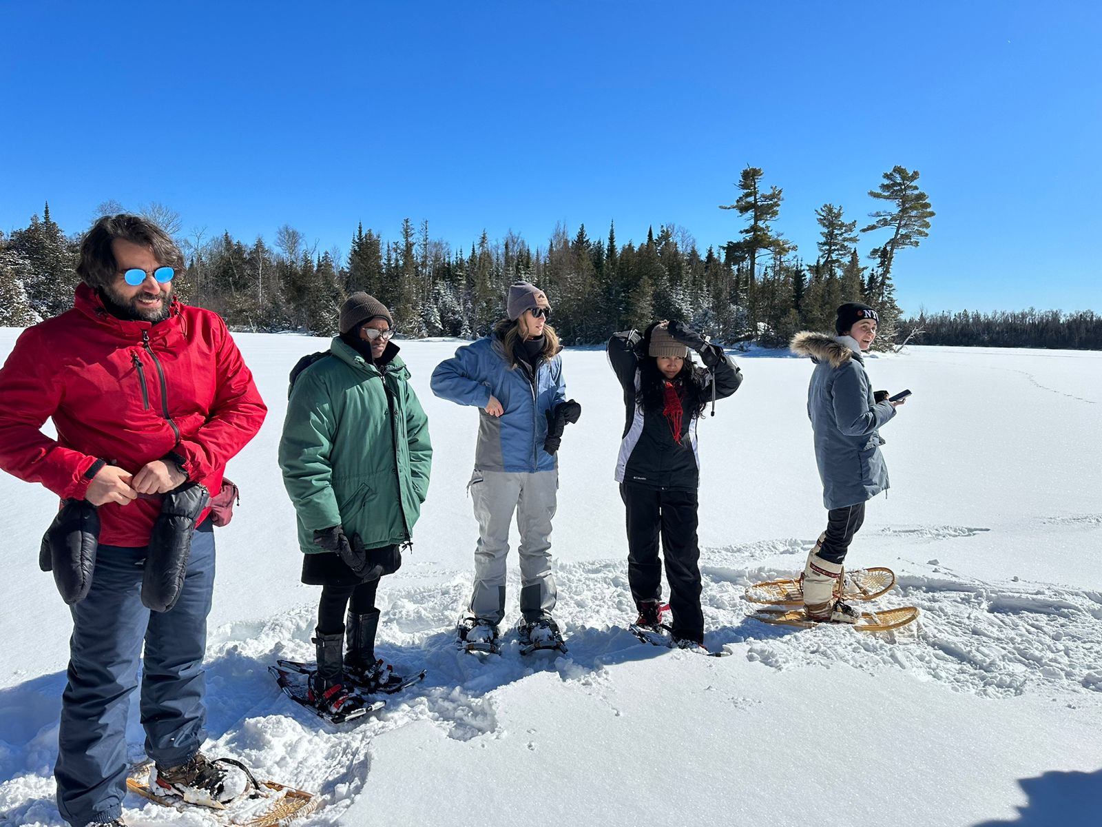 Left to right: Tare Kai, Fauziyya Tukur, Bridget Rollason, Piyumi Fonseka on the frozen lake in Gunflint Trail ready for snowshoeing.